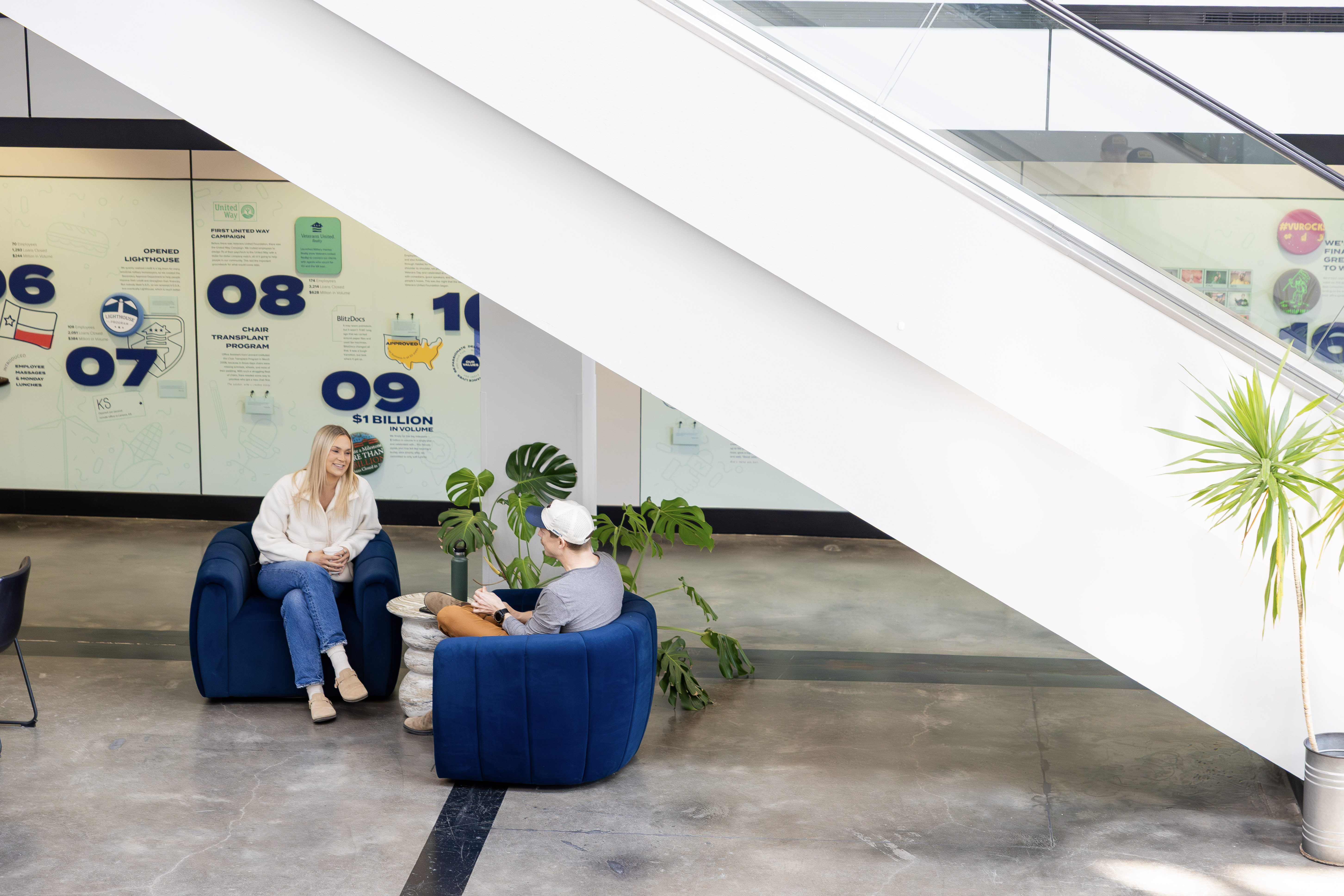 Two people chatting in Jake Atrium