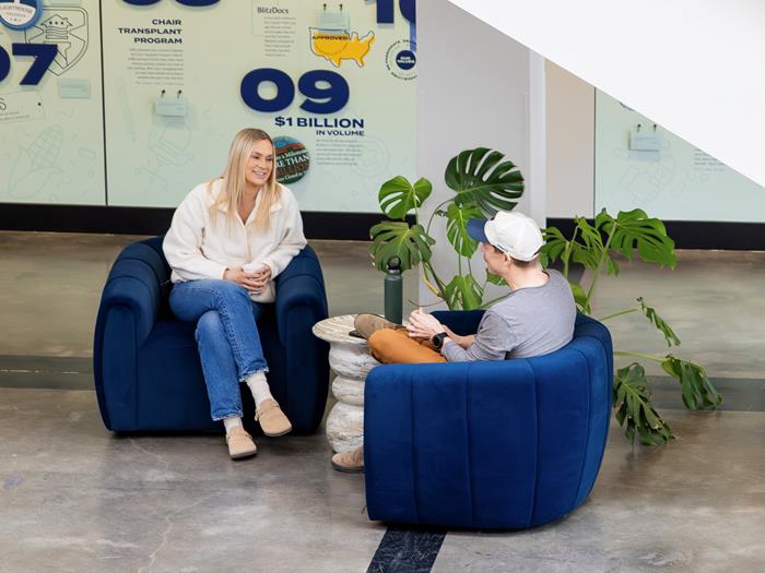 Two people chatting in Jake Atrium