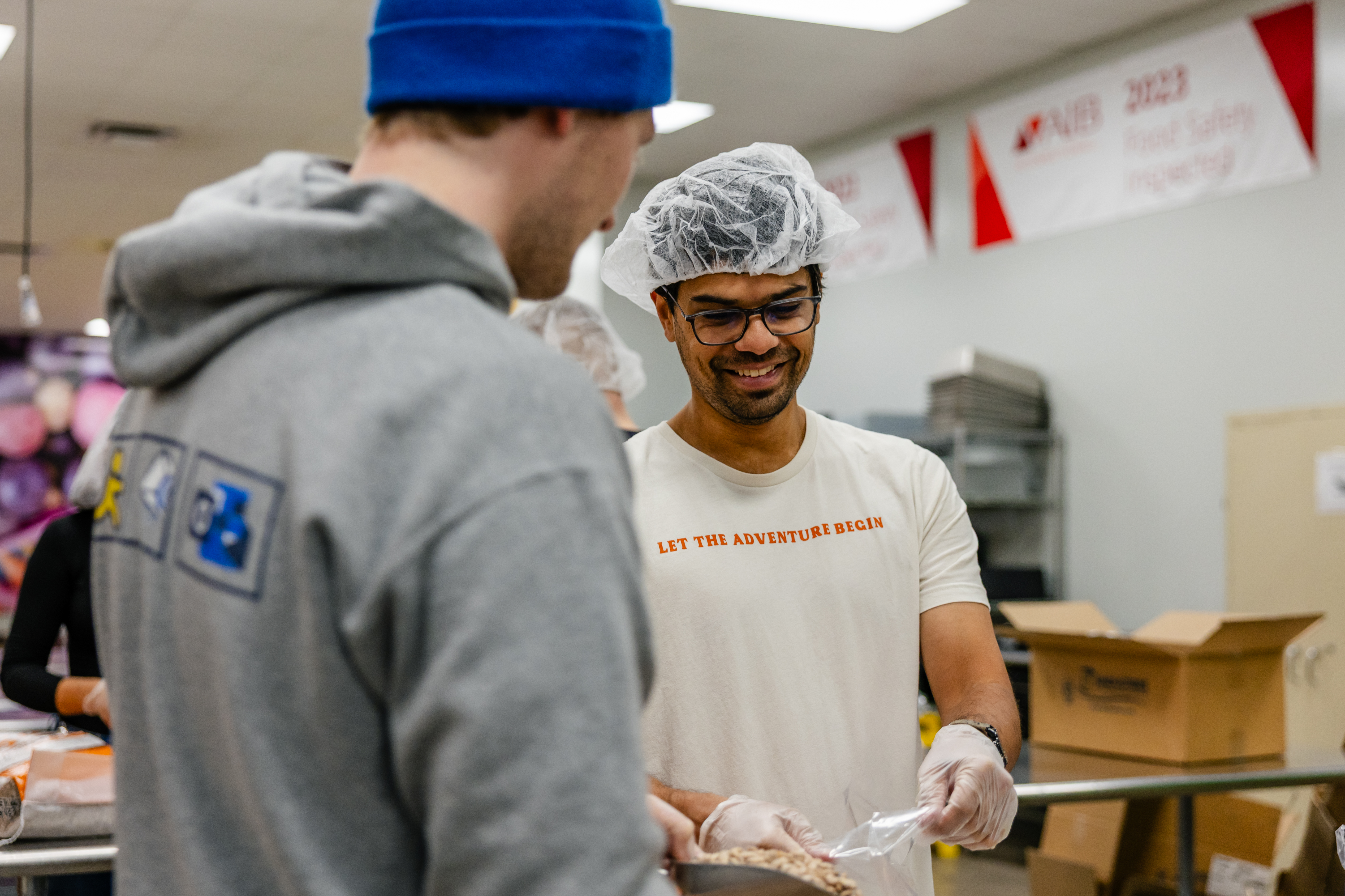 Two men volunteering at the food bank.