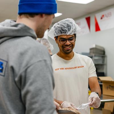 Two men volunteering at the food bank.