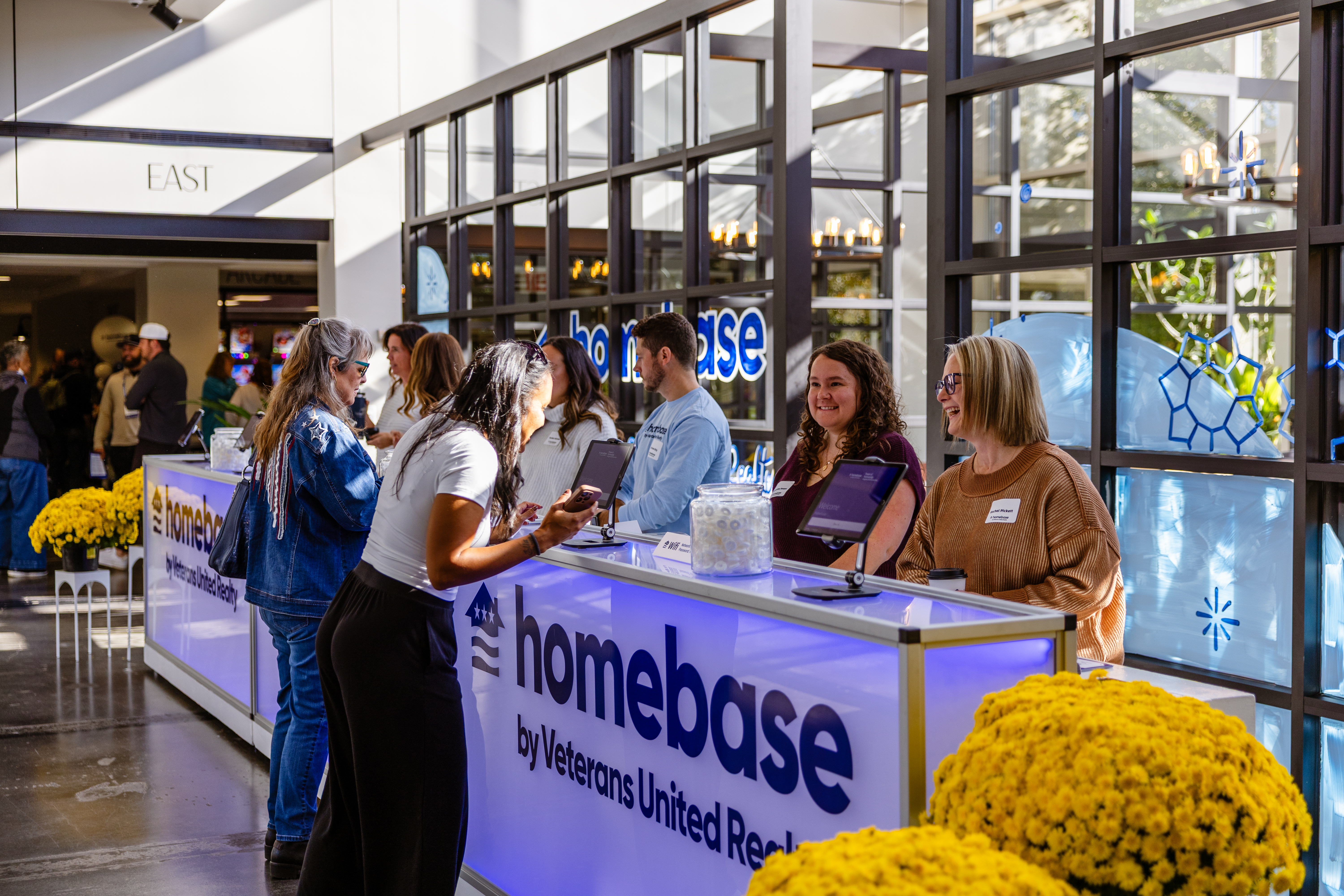 Clients chatting with VUers at our Homebase by Veterans United Realty Conference