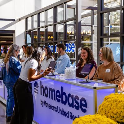 Clients chatting with VUers at our Homebase by Veterans United Realty Conference
