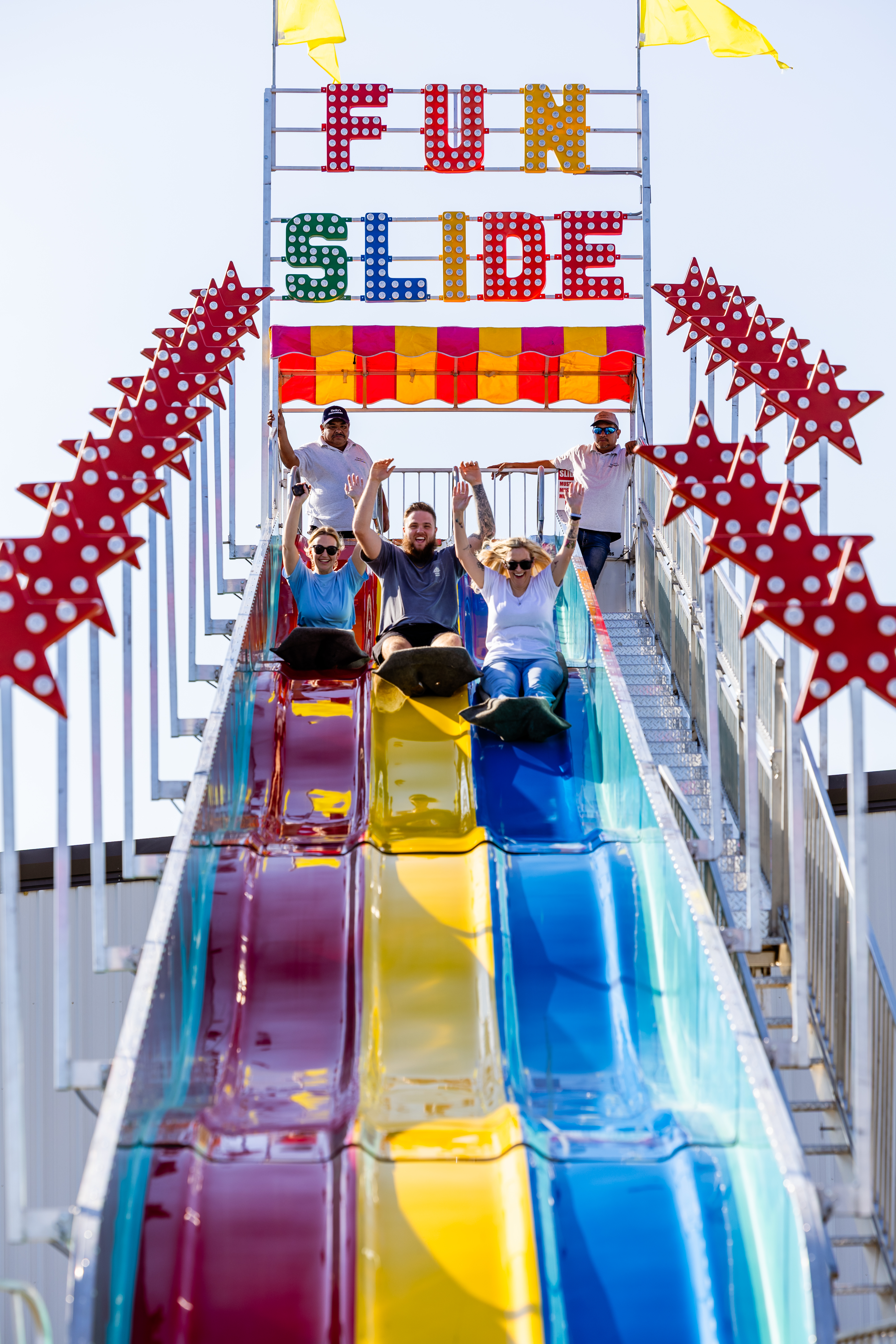 Group of co-workers going down a fun slide at the Loan Officer retreat