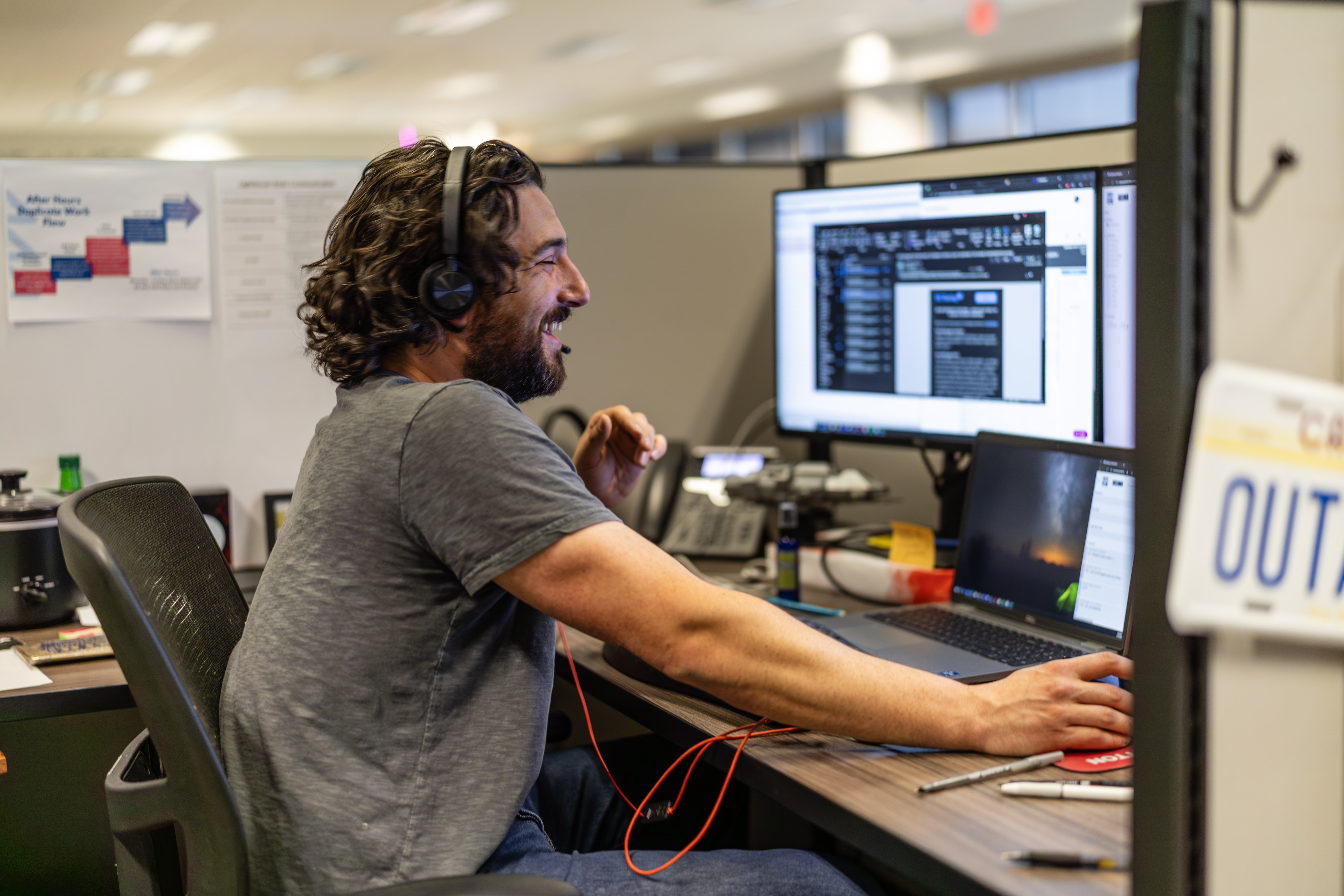 Man smiling at his computer.