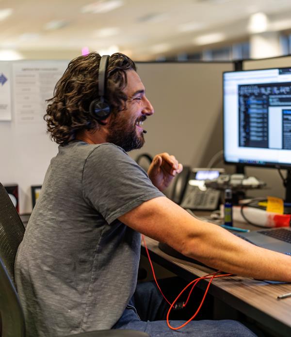 Man smiling at his computer.