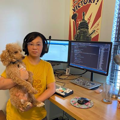 Person with dog at computer