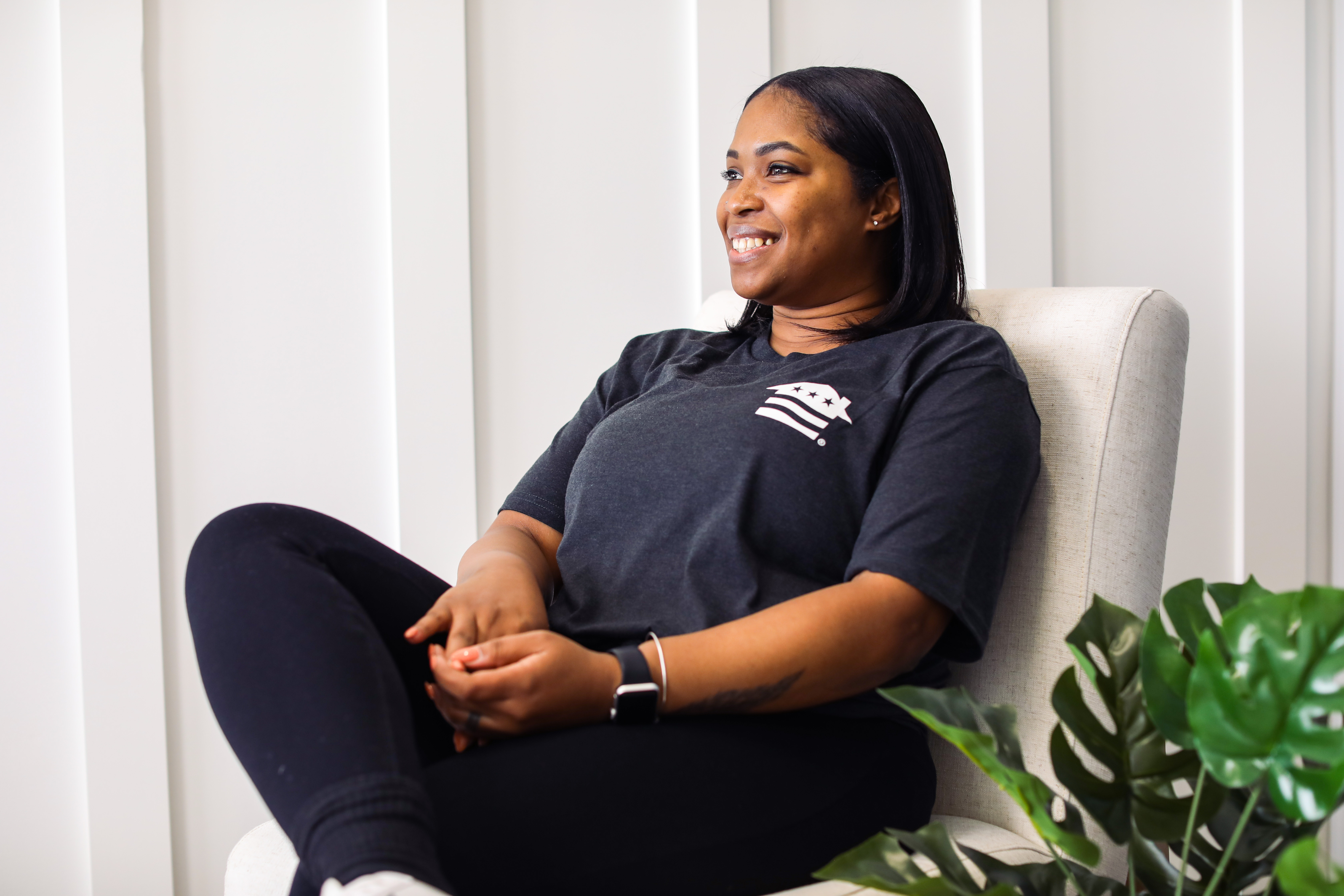 A smiling woman sitting in a chair
