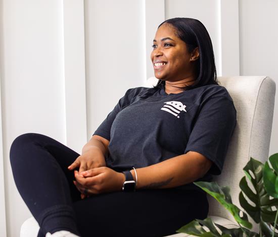 A smiling woman sitting in a chair