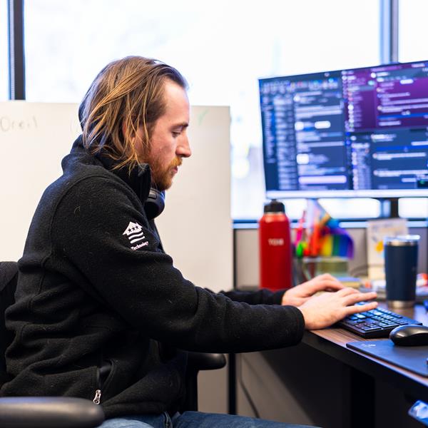 man in technology working on computer