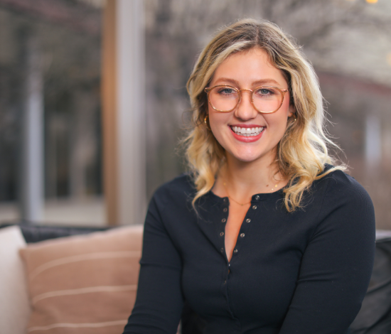 A woman with blond hair and glasses