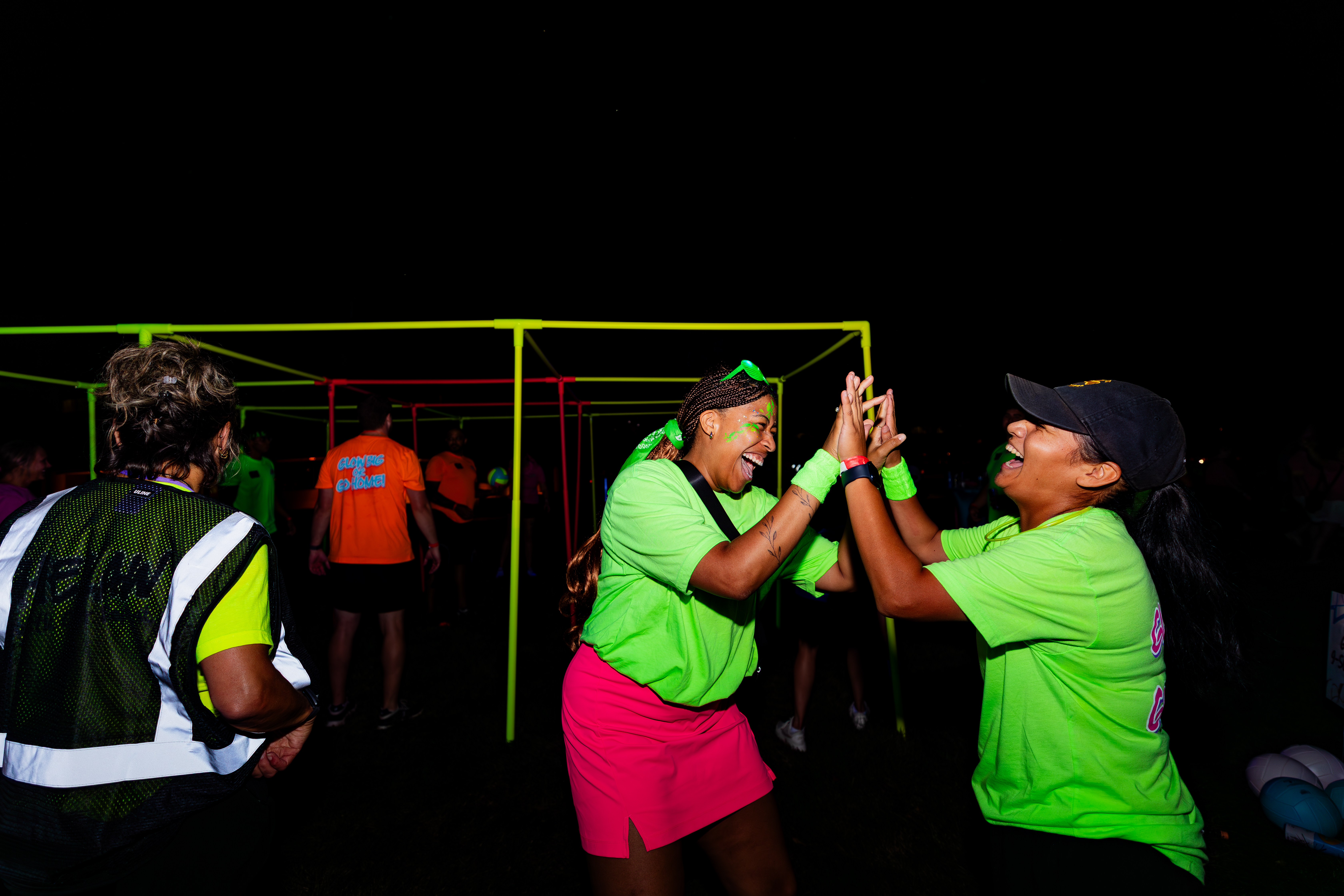 Two VUers high-fiving at Neon Gauntlet