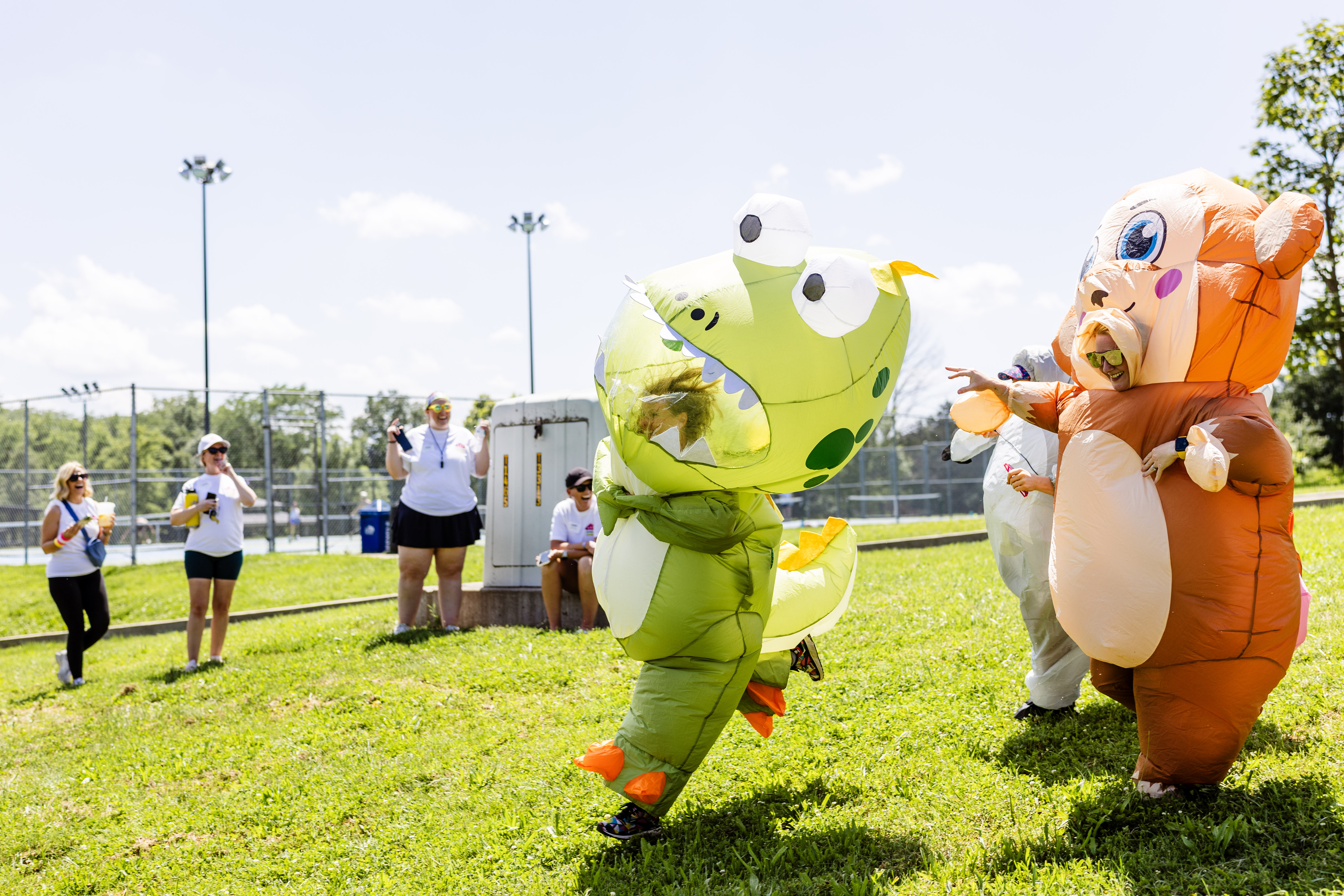 Co-workers in inflatable costumes running around.