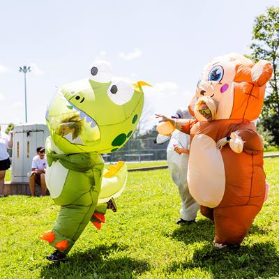 Co-workers in inflatable costumes running around.
