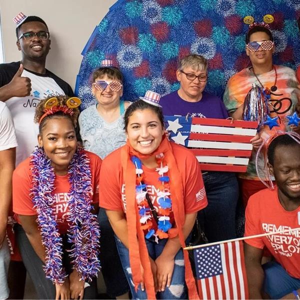 Colleagues waving america flags