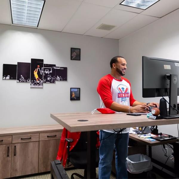 A man working at a stand up desk