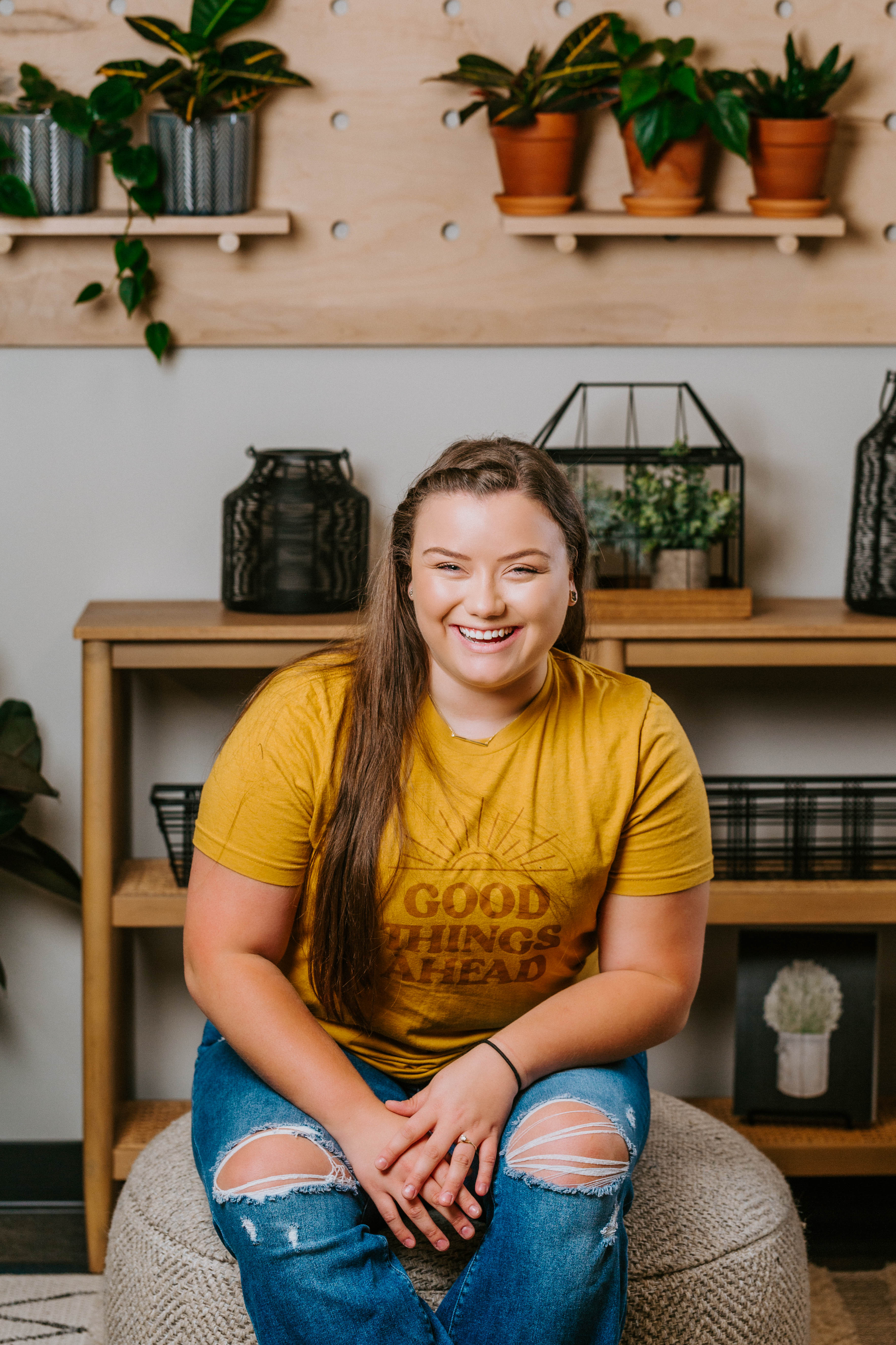 A woman smiling in front of plants