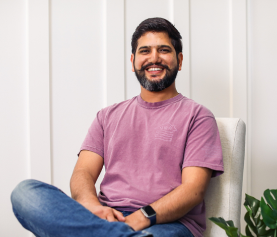 A smiling man with facial hair